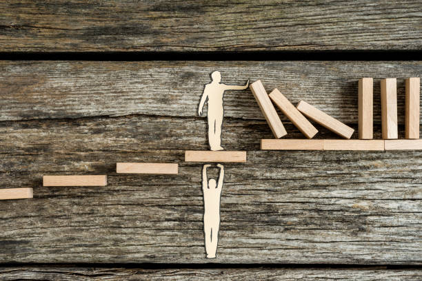 istock Conceptual paper man helping other with support 1226877536