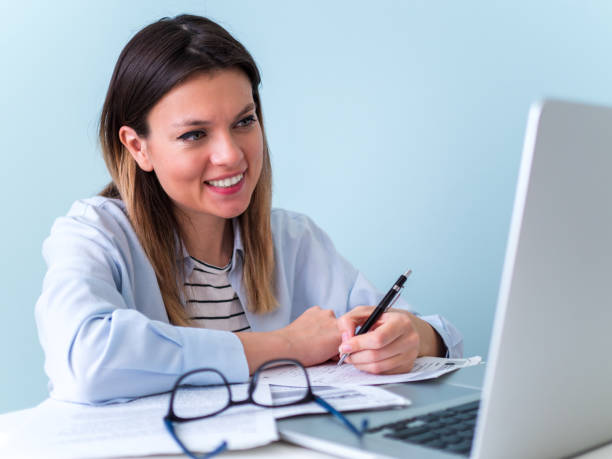 istock Distance learning online education. Woman studying with laptop, watching webinar 1226879065