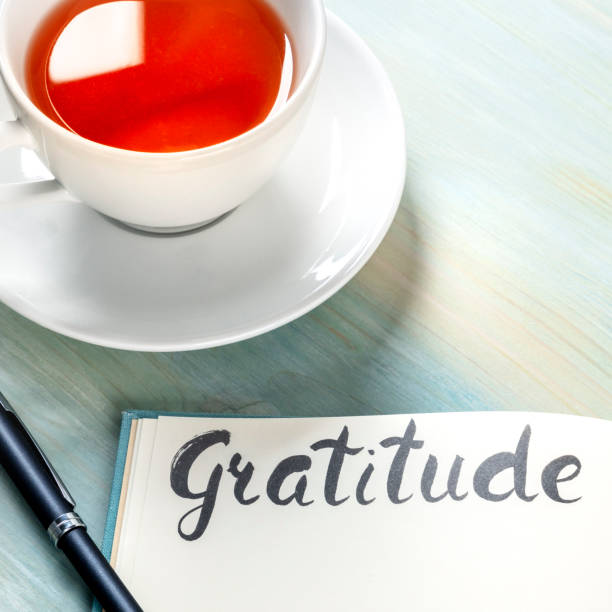 istock Gratitude journal with a pen and a cup of tea, square image 1226879315