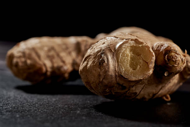 istock Ginger root in macro photo on black background. side view. volume mature product. Against viruses and diseases 1226880494