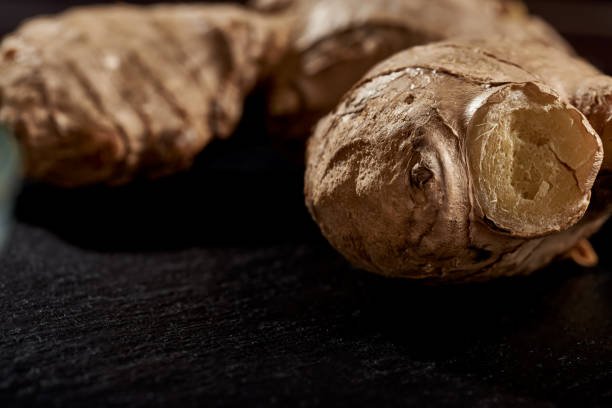 istock Ginger root in macro photo on black background. side view. volume mature product. Against viruses and diseases 1226880513