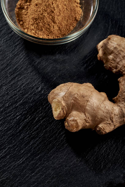 istock Ground ginger in a plate. Ginger root on a black background. top view. volume ripe product. macro photo. Against viruses and diseases. 1226880533