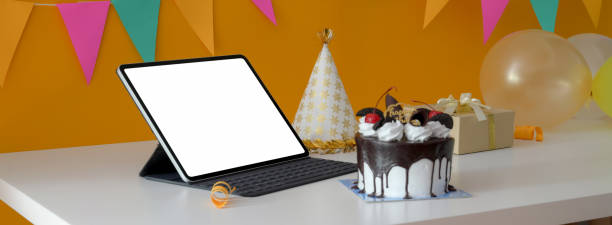 istock Online birthday party concept with blank screen tablet, cake, party hat and present box 1226881192