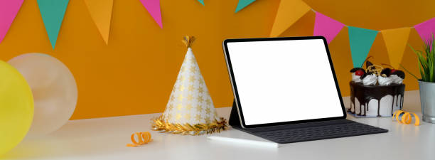 istock Online birthday party concept with blank screen tablet, cake and party hat on white table 1226881207