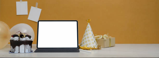 istock Online birthday party concept with mock-up tablet, cake, present box and decorations 1226881221