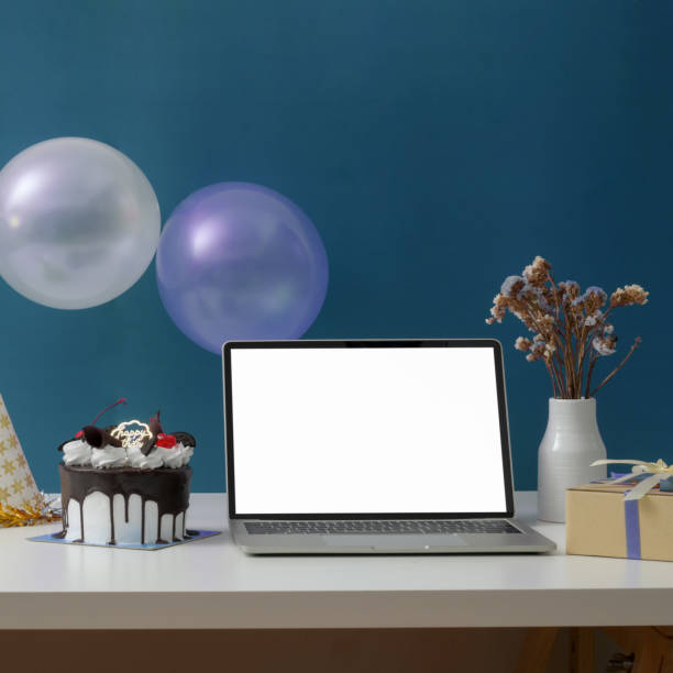 istock Online birthday party concept with blank screen laptop, cake, party hat and decorations 1226881237