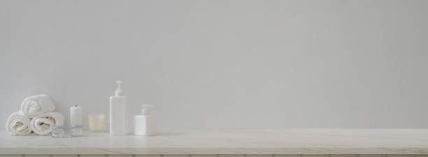 istock Marble counter with white bathroom accessories, white towels, candles and copy space 1226881752