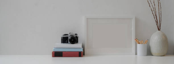 istock Modern home interior design with mock-up frame, camera, books, stationery and decorations 1226881766