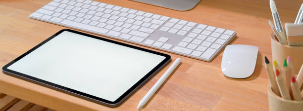 istock Wooden office desk with blank screen tablet, stylus and computer devices 1226881779