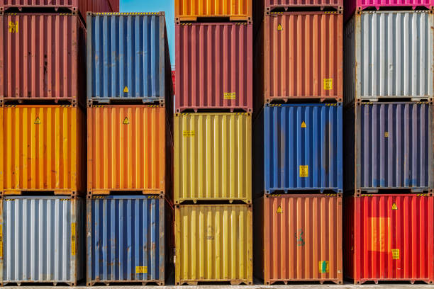Multicolor shipping containers stacked high at a port. Multicolor shipping containers stacked high at a port. cargo container stock pictures, royalty-free photos & images