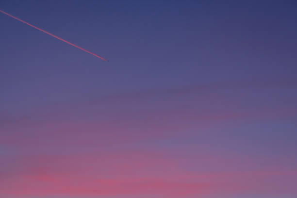 istock Aeroplane with condensation trail in dawn 1226883213