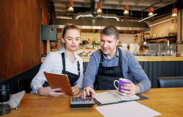 istock Young restaurant owners doing papers after hours. Start-up entrepreneurs Concept 1226887470