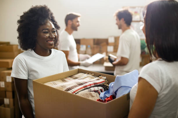 istock Volunteers carrying donations 1226887606