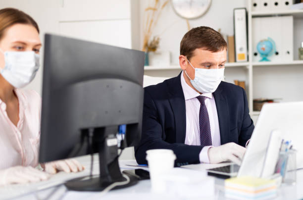 istock Use of personal protective equipment by office workers 1226889007