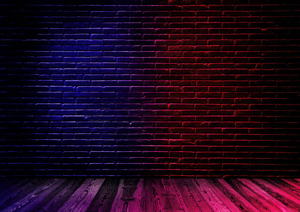istock Studio dark room black brick wall with wooden floor and lighting effect red and blue. 1226889492