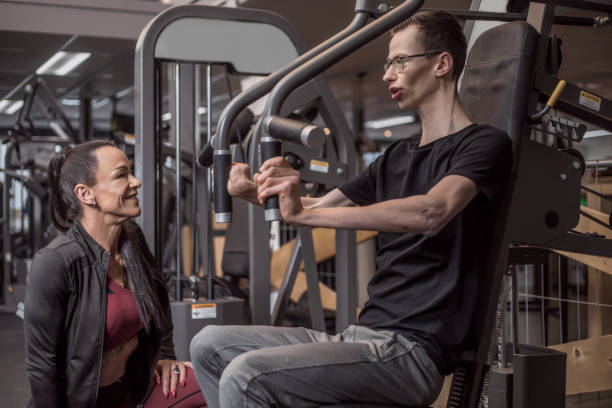istock Beautiful woman coaching disabled young athlete during Gym Workout 1226890431