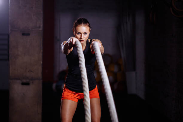 istock Woman make exercise with battle rope in functional training gym 1226890479