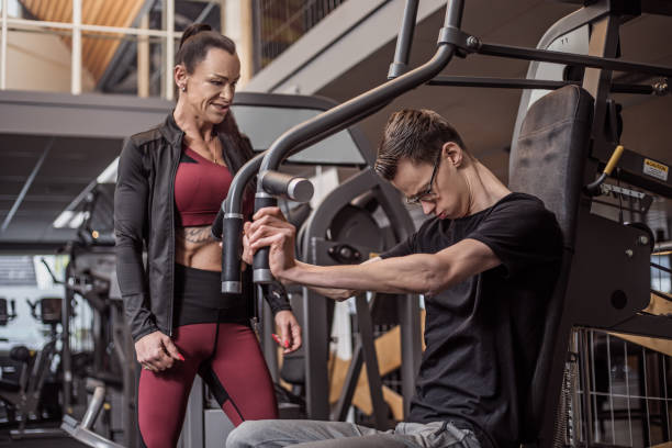 istock Beautiful woman coaching disabled young athlete during Gym Workout 1226890497