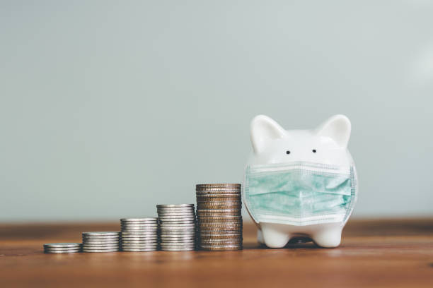 istock Piggybank in mask with stack coin on wood. 1226890914