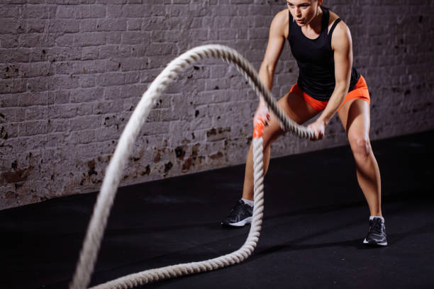 istock Woman make exercise with battle rope in functional training gym 1226891570
