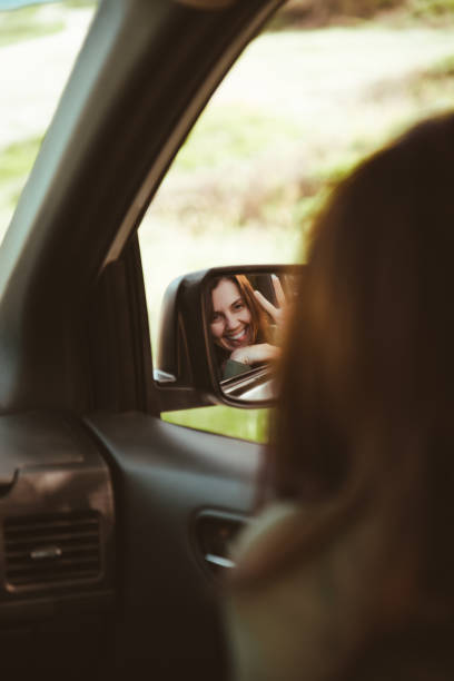 istock reflection on stunning smiling woman in car rear mirror 1226893667