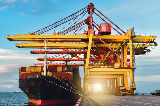 istock Reach stacker unload container from truck in container yards, Logistics operations. 1226893812