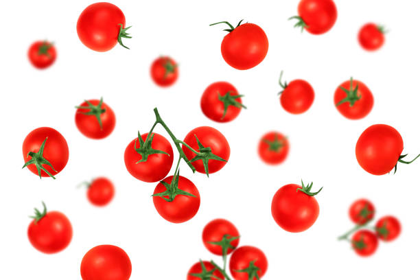 istock Falling red cherry tomatoes isolated on a white background with clipping path as package design element. Flying food 1226896951
