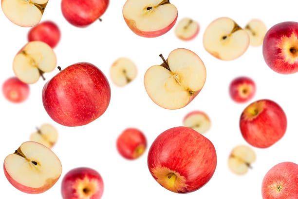 istock Falling red apples isolated on a white background with clipping path as package design element. Flying fruits 1226896963