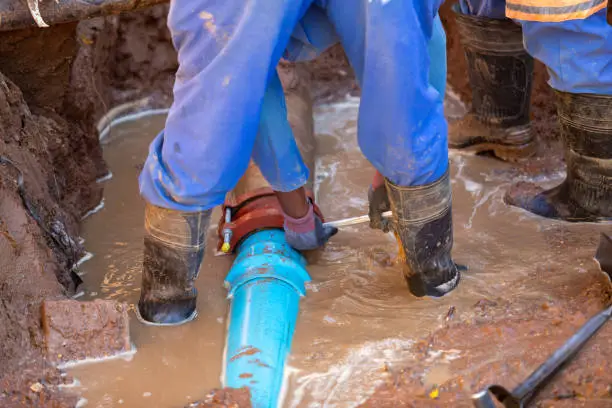 Two African repairman attending to the city water supply repairs in Gaborone Botswana