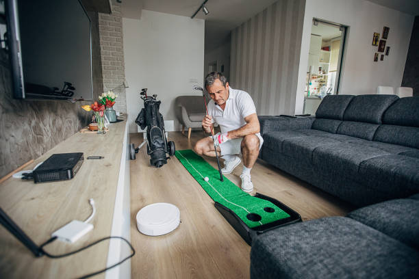 istock Senior man playing mini golf at home 1226903325