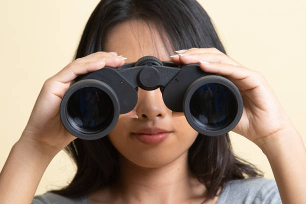 istock Young Asian woman with binoculars. 1226906066