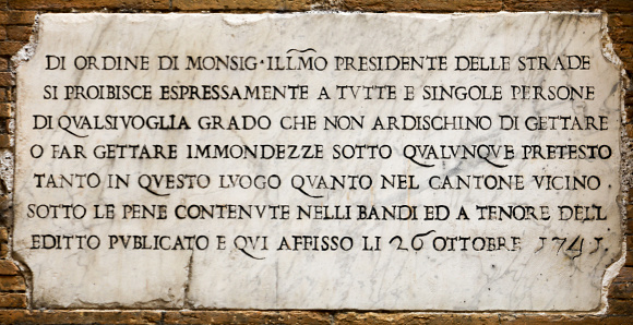 Rome, Italy -- A travertine marble plaque with an ancient warning notice in a street in the historic center of Rome. The plaque indicates in a ancient italian language: \