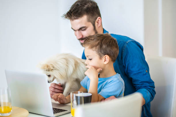 istock Young man and his son using a laptop Stock photo 1226911756