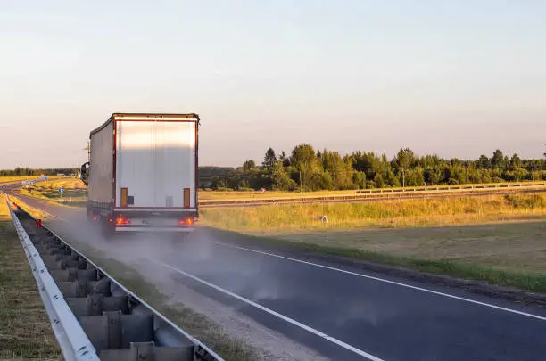 Photo of Emergency braking of a loaded truck on dry asphalt. Safety concept and stopping distance with ABS, copy space