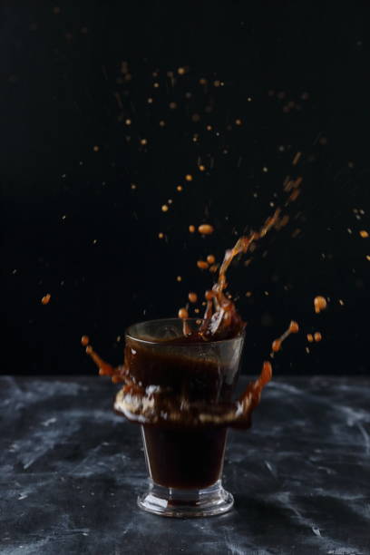 istock Coffee splash, A glass of cold coffee on a black background 1226915399