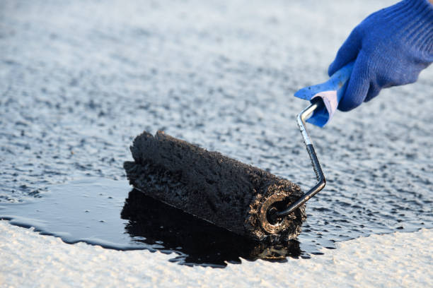 istock Worker applies bitumen mastic on the foundation 1226917270