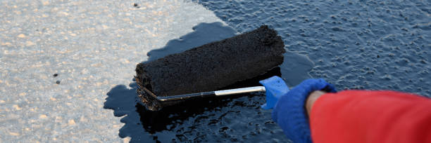 istock Worker applies bitumen mastic on the foundation 1226917276