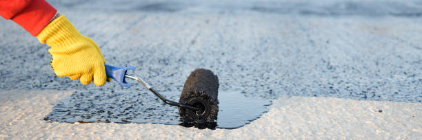 istock Worker applies bitumen mastic on the foundation 1226917568