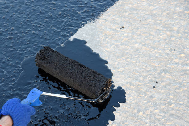 istock Worker applies bitumen mastic on the foundation 1226917870