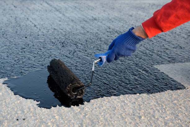 istock Worker applies bitumen mastic on the foundation 1226917889