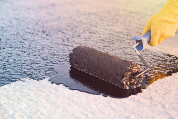istock Worker applies bitumen mastic on the foundation 1226917905