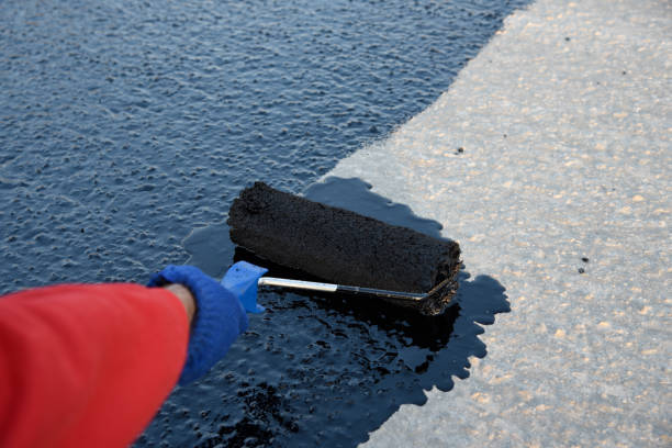 istock Worker applies bitumen mastic on the foundation 1226917906