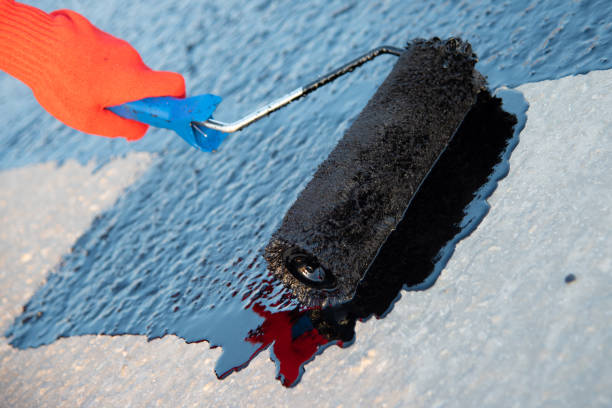 istock Worker applies bitumen mastic on the foundation 1226917914