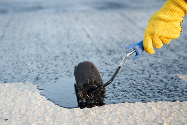 istock Worker applies bitumen mastic on the foundation 1226917915
