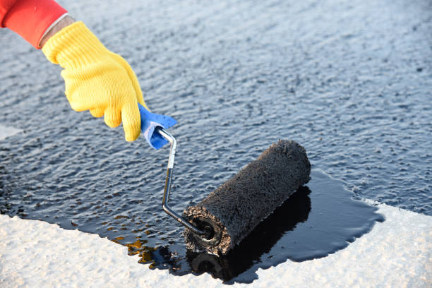 istock Worker applies bitumen mastic on the foundation 1226917967