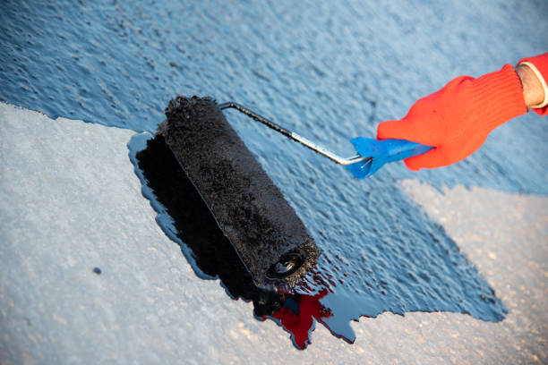 istock Worker applies bitumen mastic on the foundation 1226917999