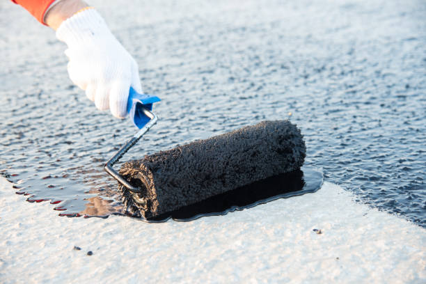 istock Worker applies bitumen mastic on the foundation 1226918051