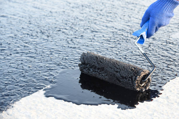 istock Worker applies bitumen mastic on the foundation 1226918065