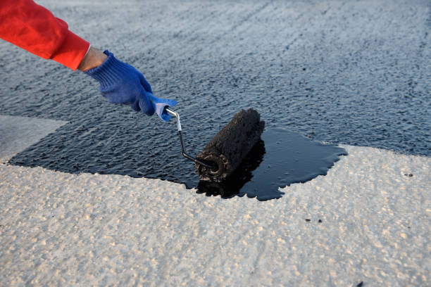 istock Worker applies bitumen mastic on the foundation 1226918079
