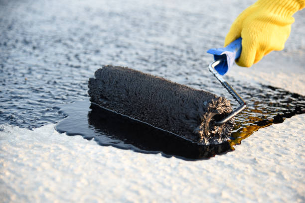 istock Worker applies bitumen mastic on the foundation 1226918102